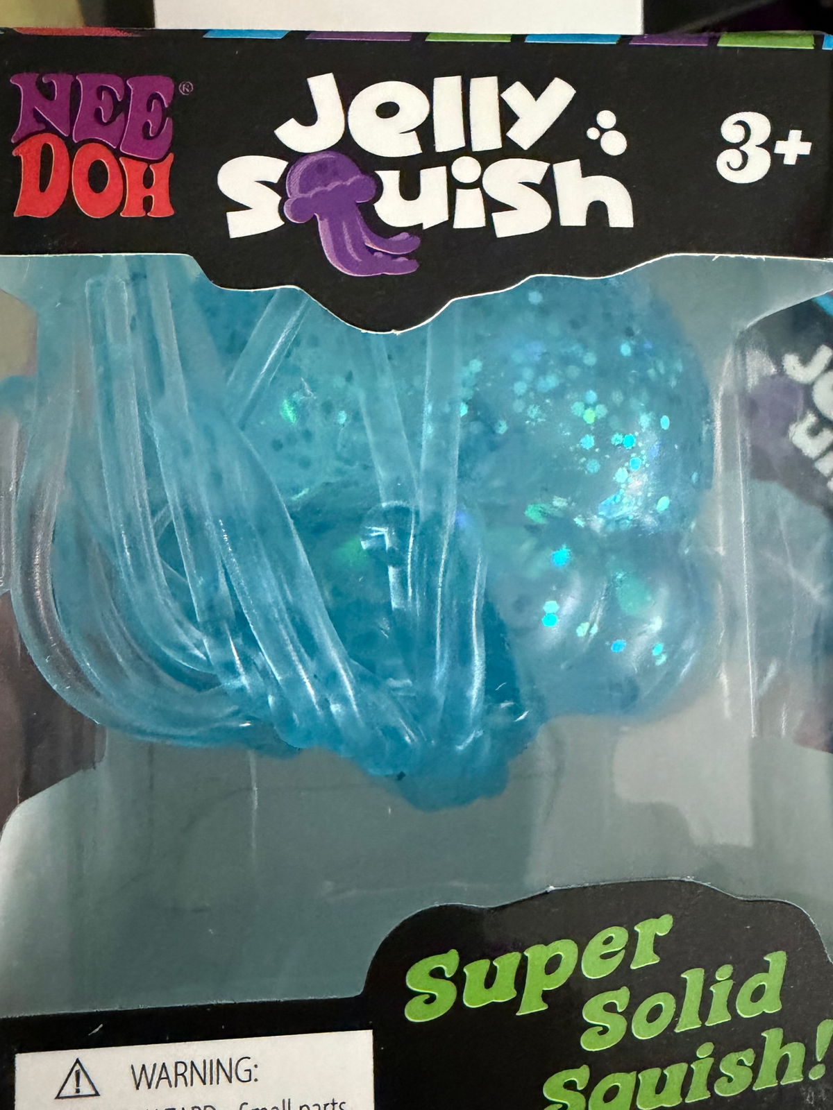 Jellyfish-shaped solid squish toy with logo design